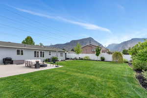 View of yard featuring an outdoor living space, a patio, and a mountain view