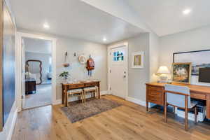 Foyer with light wood finished floors, baseboards, and recessed lighting