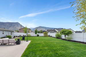 View of yard featuring a mountain view, a patio area, and a residential view