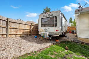 View of yard featuring fence and cooling unit