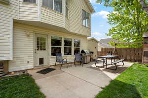 View of patio with a grill