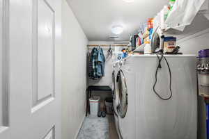 Laundry area featuring washer and clothes dryer and baseboards