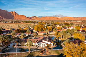 Aerial view of property's location featuring nearby suburban area and a water and mountain view