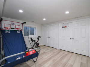 Rec room featuring light wood-style flooring and recessed lighting