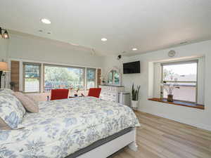 Bedroom with light wood-style flooring, recessed lighting, and baseboards