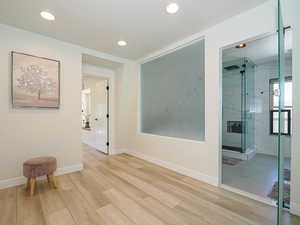 Hall featuring light wood finished floors, recessed lighting, and baseboards