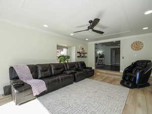 Living area featuring light wood-type flooring, ornamental molding, ceiling fan, and recessed lighting