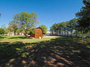 View of yard with a barn and an outdoor structure