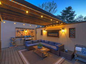 Wooden terrace with an outdoor living space and grilling area