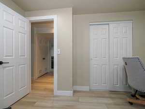 Unfurnished office with baseboards and light wood-style floors
