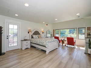 Bedroom with light wood-style flooring, access to outside, and recessed lighting
