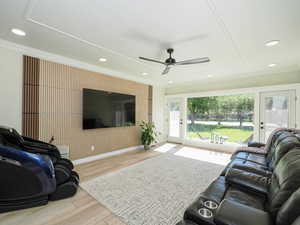 Living area with ceiling fan, light wood finished floors, crown molding, baseboards, and recessed lighting