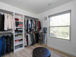 Walk in closet featuring wood finished floors