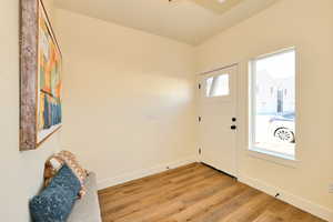 Foyer featuring baseboards and light wood finished floors