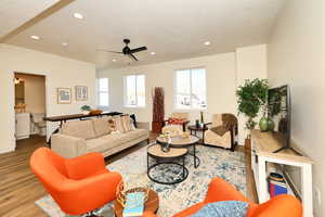 Living room with a textured ceiling, wood finished floors, recessed lighting, a ceiling fan, and baseboards