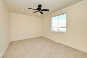 Bedroom with light carpet, baseboards, recessed lighting, ceiling fan, and a textured ceiling