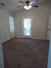Unfurnished room with ceiling fan, lofted ceiling, carpet floors, and baseboards