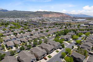 Aerial view of property's location featuring a mountain backdrop and nearby suburban area