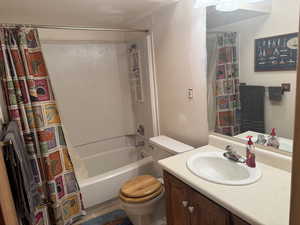 2nd Full bath featuring toilet, shower / tub combo, and vanity