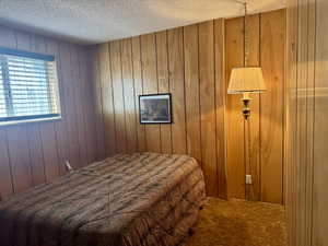 One of three downstairs bedroom featuring large window and closet.