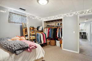 Carpeted bedroom featuring a closet