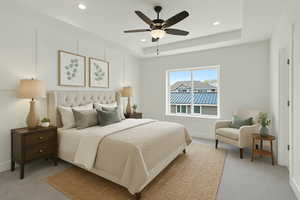 Bedroom featuring light colored carpet, recessed lighting, baseboards, a raised ceiling, and ceiling fan