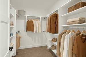 Walk in closet with carpet flooring
