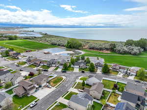 Aerial view of residential area featuring a nearby body of water and a golf club