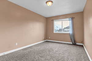 Spare room with carpet floors and baseboards