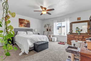 Bedroom with carpet flooring, baseboards, and ceiling fan