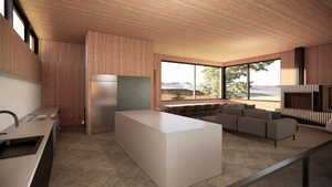 Kitchen with modern cabinets, wood walls, wood ceiling, light countertops, and a sink