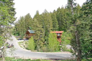 Aerial view of property and surrounding area featuring a heavily wooded area