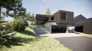 Contemporary house featuring driveway, a front yard, and a garage