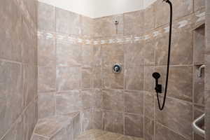 Bathroom featuring tiled shower