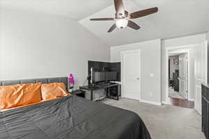 Bedroom with carpet floors, baseboards, ceiling fan, and lofted ceiling