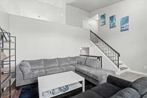 Living room with stairs and a high ceiling