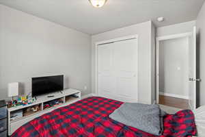 Bedroom with baseboards and a closet