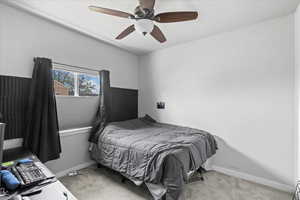 Bedroom featuring baseboards, a ceiling fan, and light colored carpet