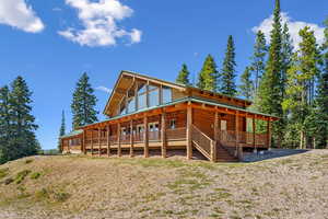 Rear view of house featuring faux log siding
