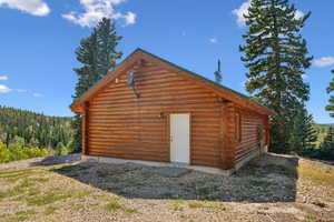 View of outbuilding with a forest view and an outbuilding