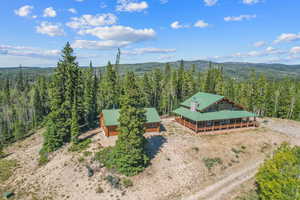 View of subject property with a forest