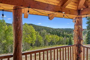 Wooden terrace featuring a view of trees