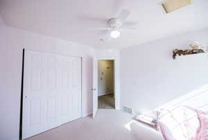Carpeted bedroom featuring a closet, a ceiling fan, and baseboards
