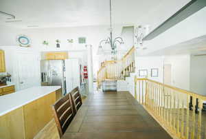 Dining area featuring a chandelier, stairs, and wood finished floors