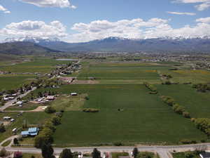 Aerial overview of property's location with a mountainous background and nearby suburban area