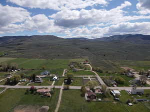Aerial view of property's location with rural landscape and a mountain backdrop