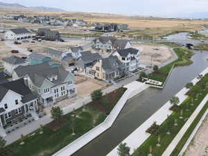 Aerial view of residential area featuring a nearby body of water