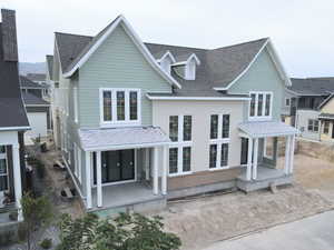 View of property featuring a shingled roof
