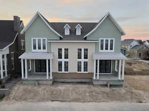 Exterior view of property featuring roof with shingles and covered porch