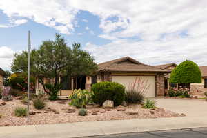 Ranch-style home with brick siding, a garage, concrete driveway, and a tile roof